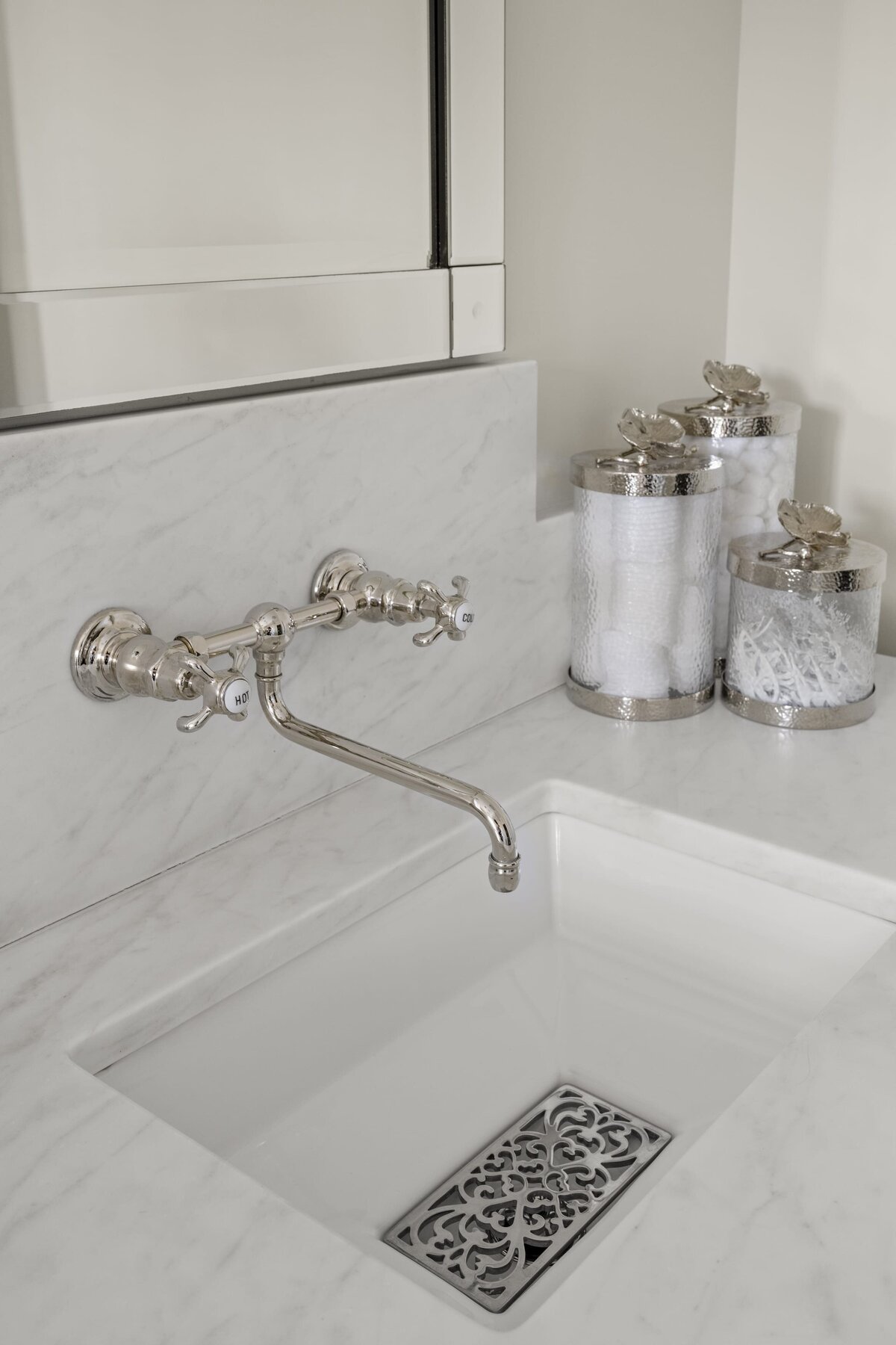 candra lynn interiors ocean port project bathroom sink with silver finsihes and marble countertop