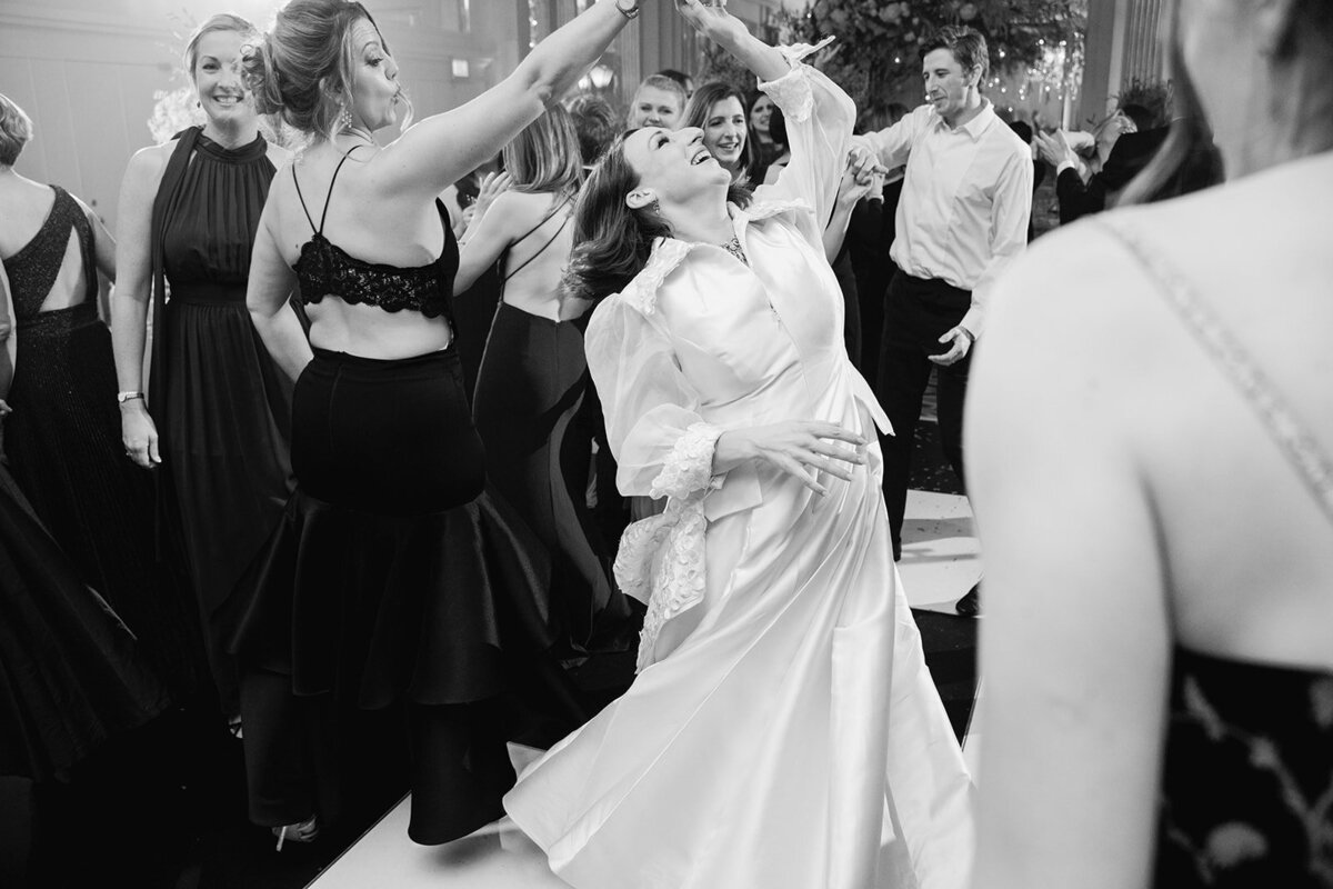 The bride dancing with wedding guest in the Claridges ballroom at her wedding