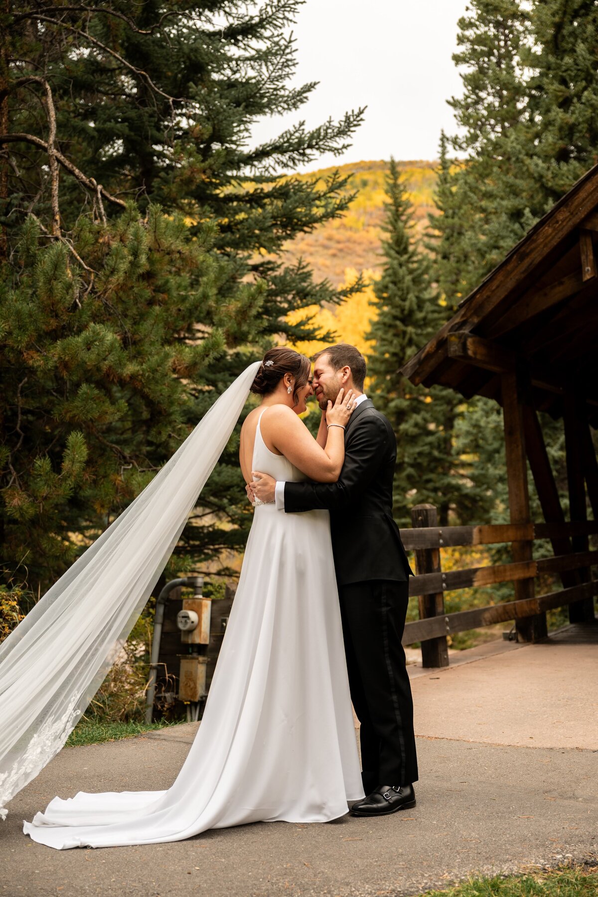 Bride and groom kiss on their wedding day in Vail, Colorado.