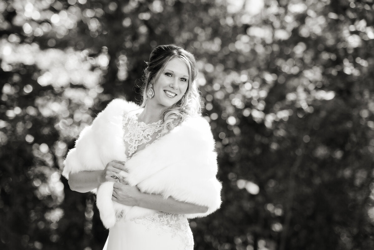 Wedding bride posing for photos wearing shawl.