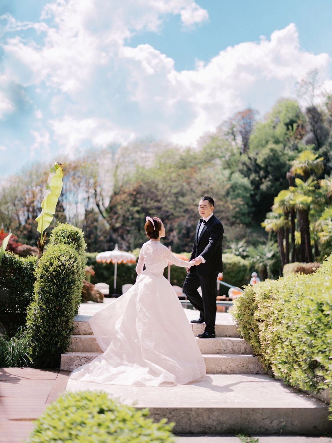 Poolside wedding portraits of a couple during Grand Hotel Tremezzo wedding, by Lake Como Wedding Photographer Andreas K. Georgiou
