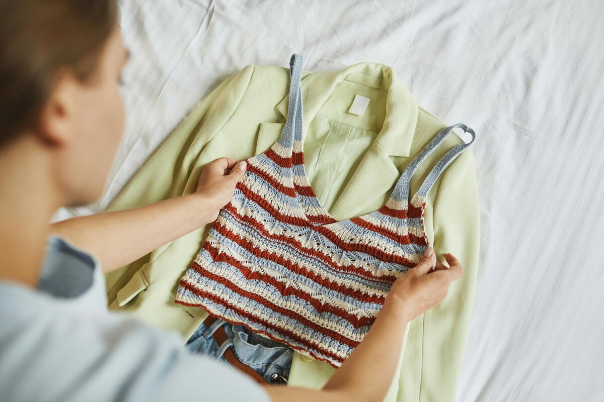 Anna Grace laying out an outfit on her bed.