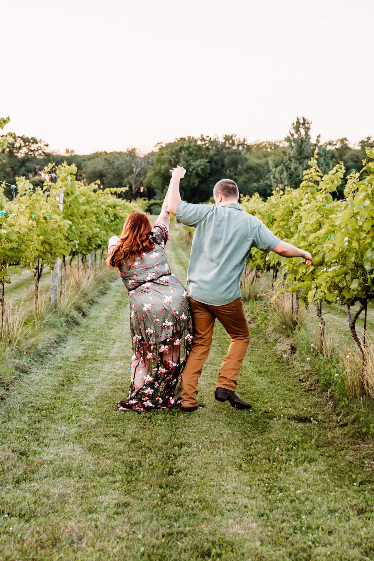 fun couple bumping hips at a winery in Ripon Wi for their couples photos