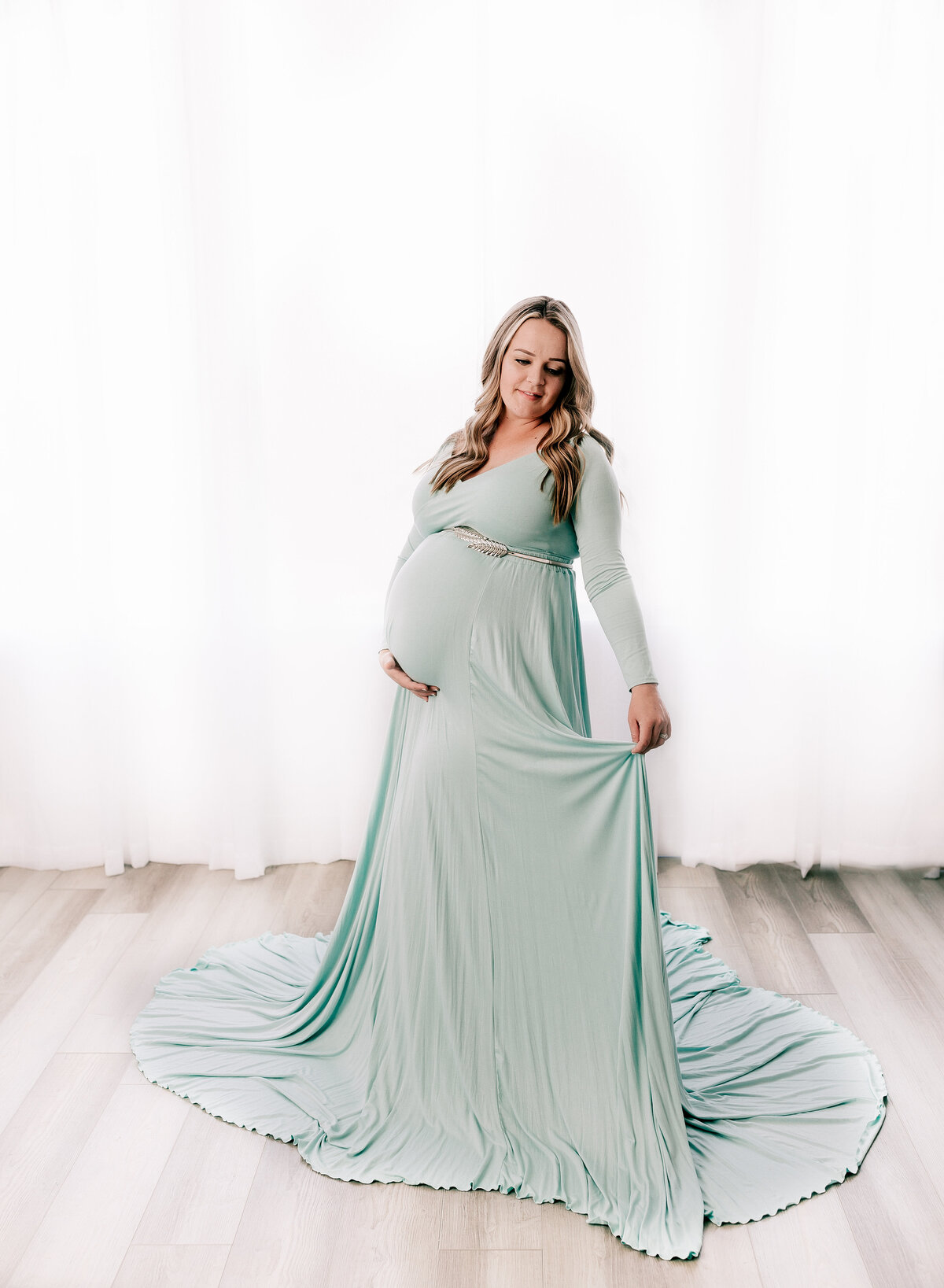 Flowy mint maternity gown in a studio maternity session in Utah.