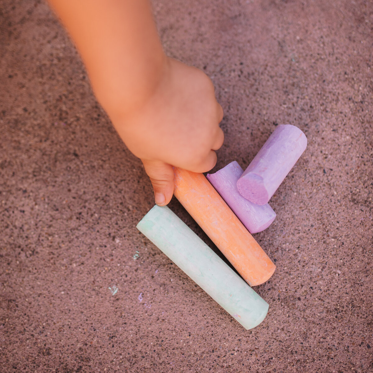 Inspired by play, our toddlers are encouraged to play outside and draw using chalk.
