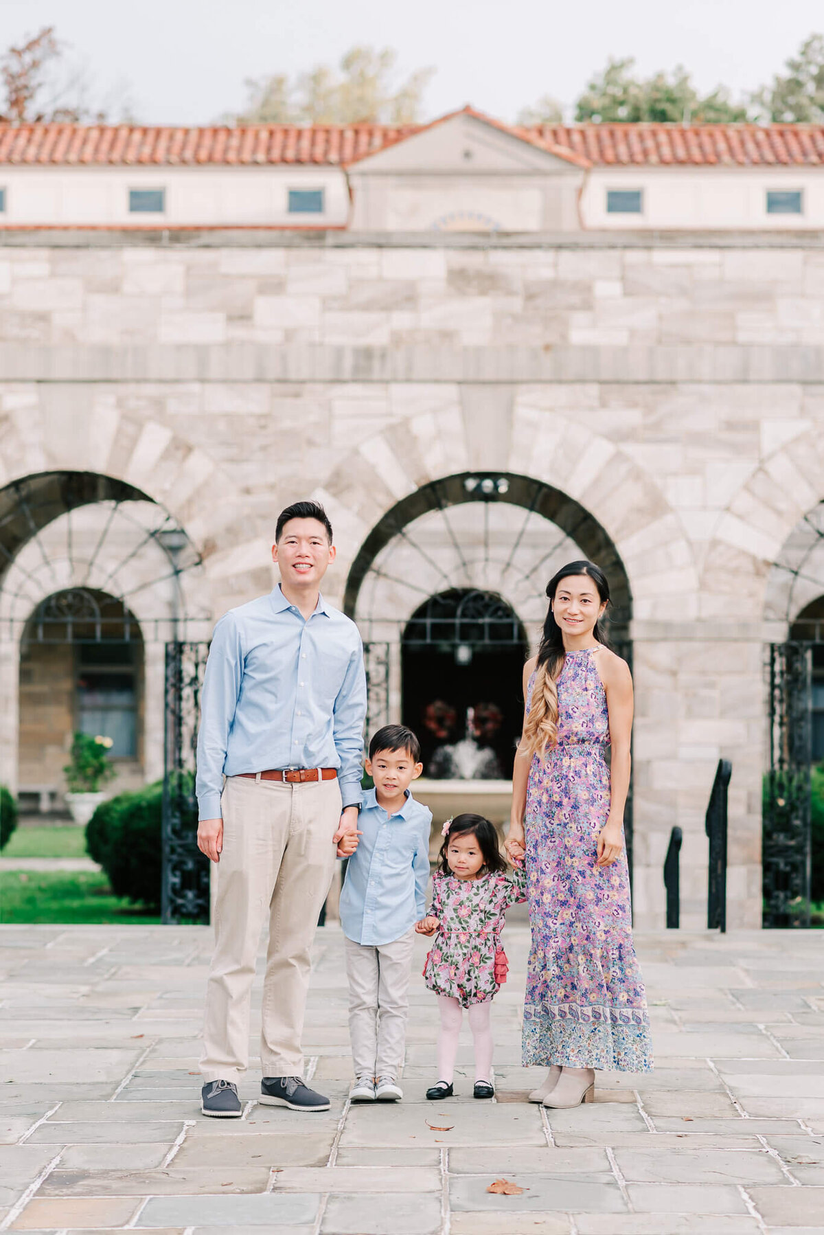 A family standing in front of St. Anthony's Shrine during their family session