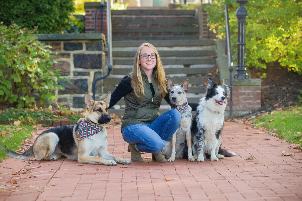 Branding photo of a dog trainer surrounded by dogs