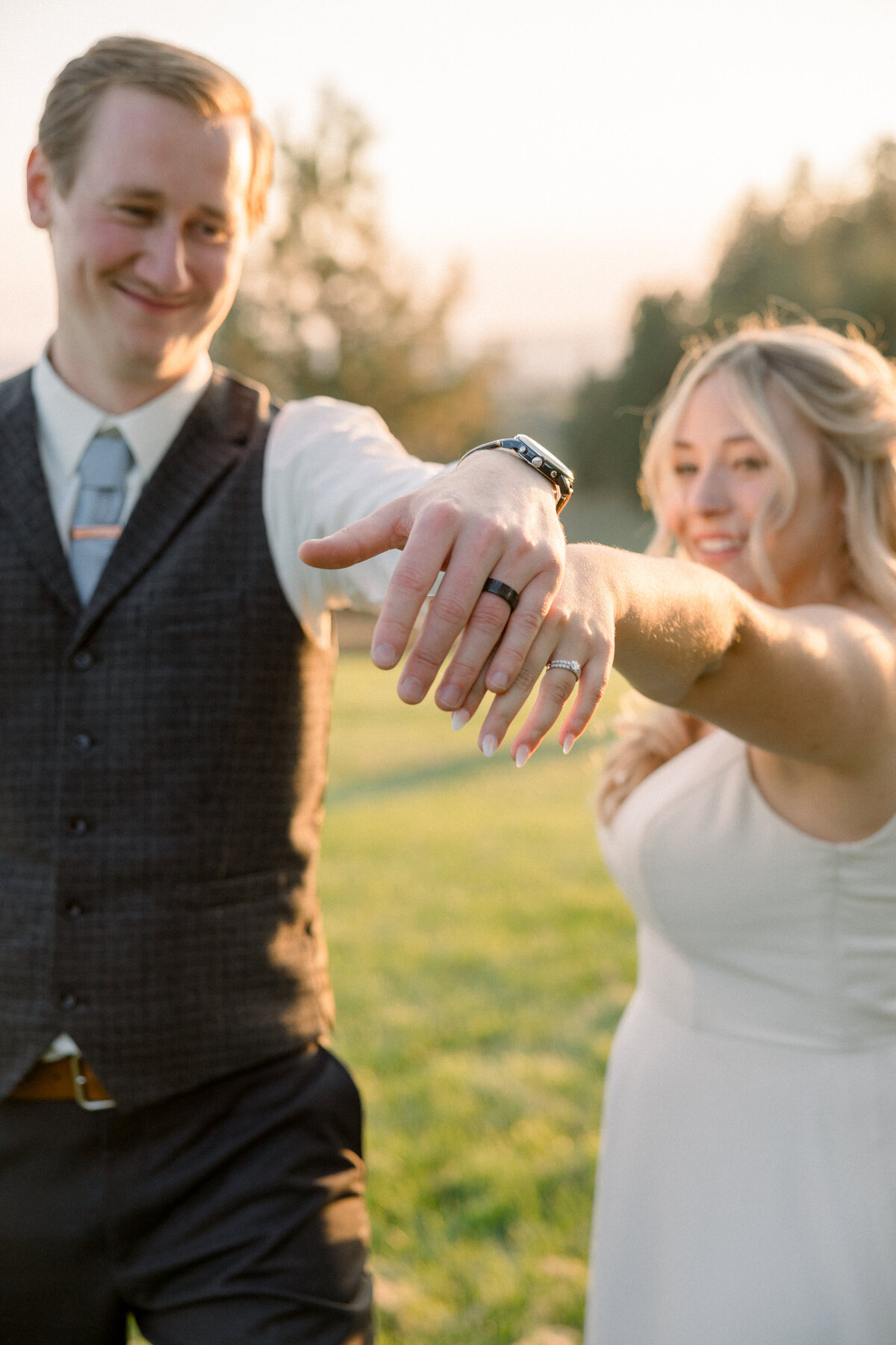 bride and groom showing off their wedding rings