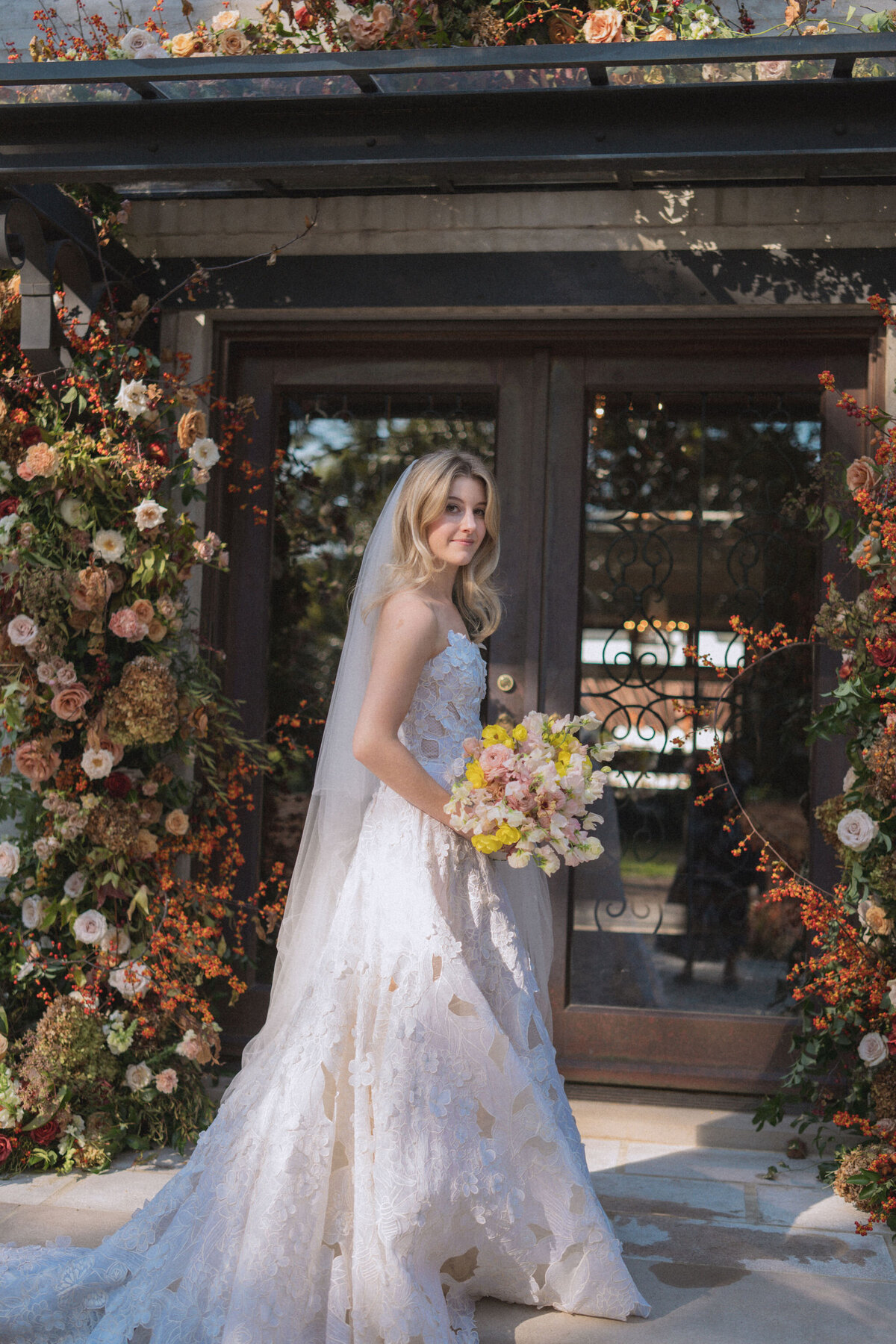 Product clustered bridal bouquet with sweet peas, local zinnias, and butterfly ranunculus. Elegant and simple bridal bouquet and bridal party bouquets with hues of blush and pops of yellow. Unique fall wedding design for private residence wedding in Nashville, TN. Bridal party wearing brown and wedding design with touches of brown. Design by Rosemary & Finch Floral Design in Nashville, TN.