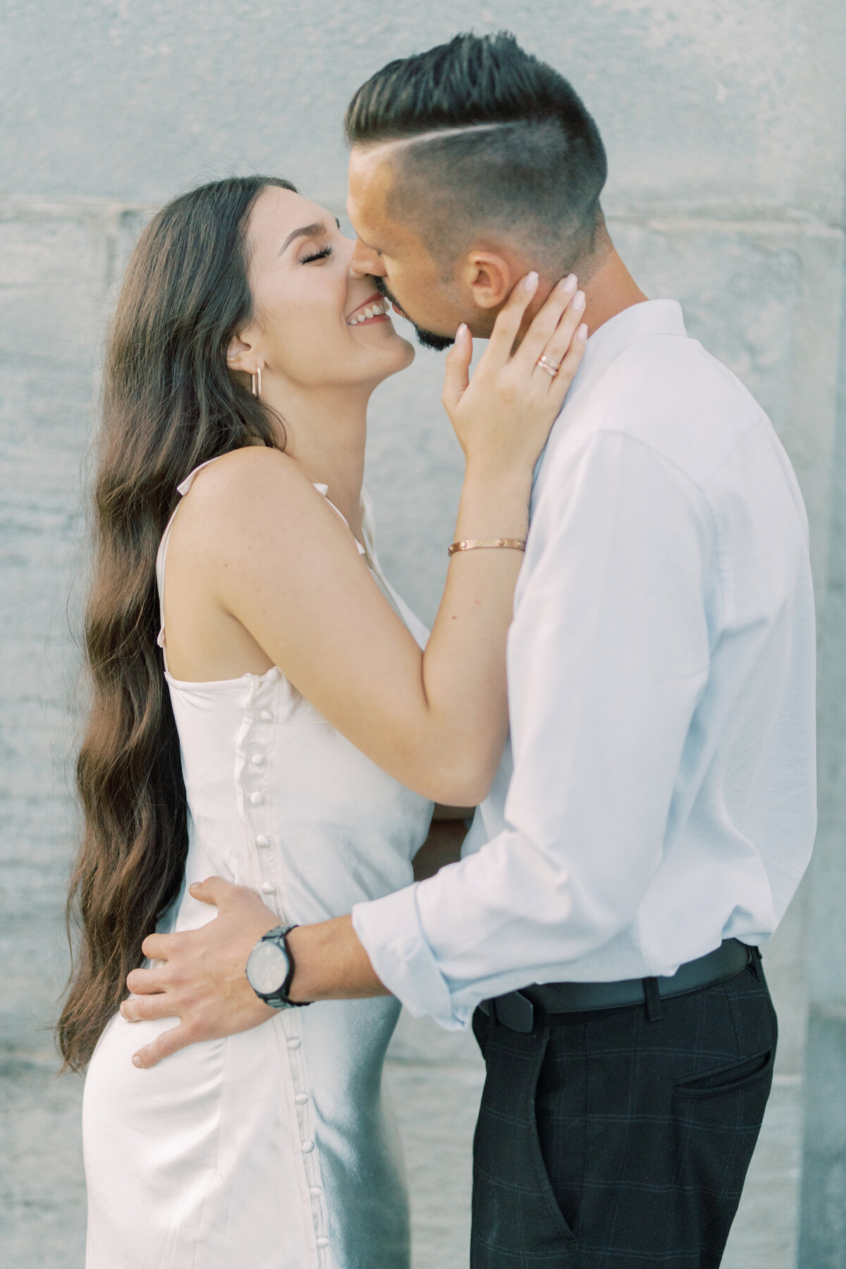 Close-up of an engaged couple sharing a gentle, intimate kiss at Toronto’s RC Harris Water Treatment Plant, their joy and connection radiating