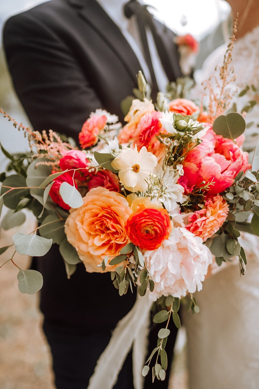 pink orange and red wedding flower bouquet