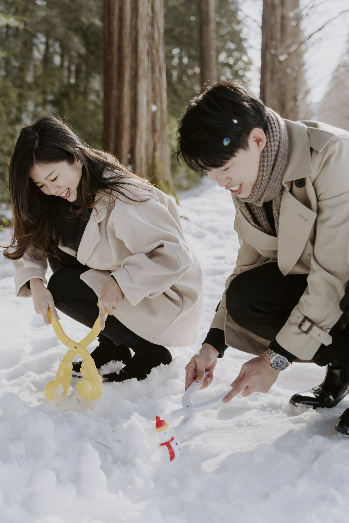 the couple playing in the snow at metasequoia road in damyang south korea