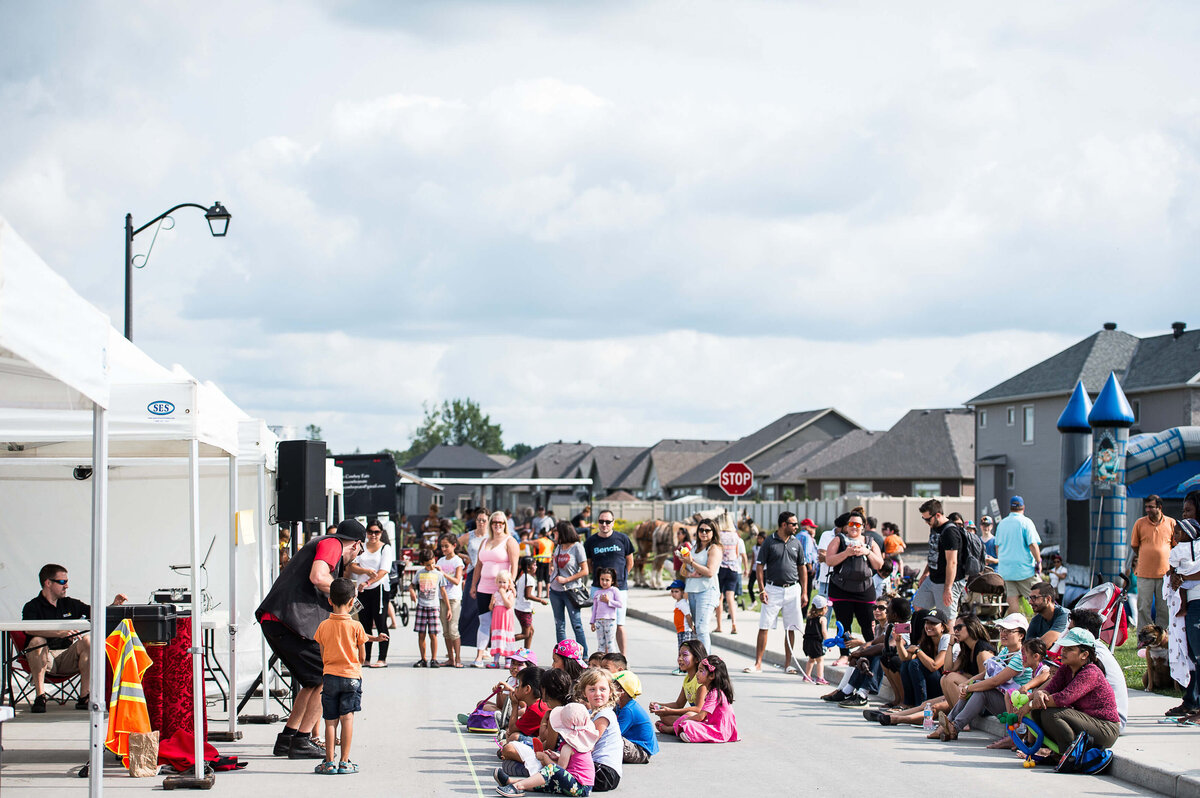 a wide angle street view of a children's corporate event showing children watching a magic show.  Captured by JEMMAN Photography COMMERCIAL