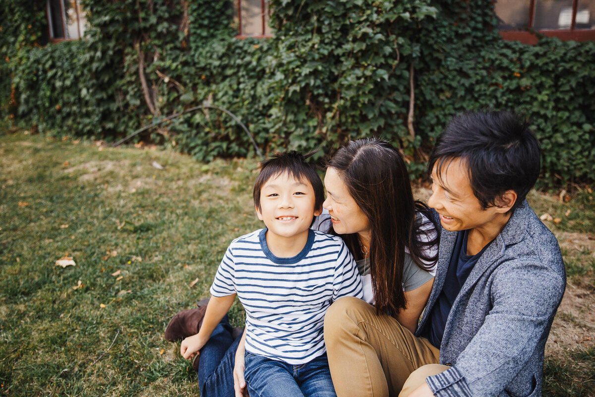 Parents smiling at 9 year old son during family photography session in Toronto