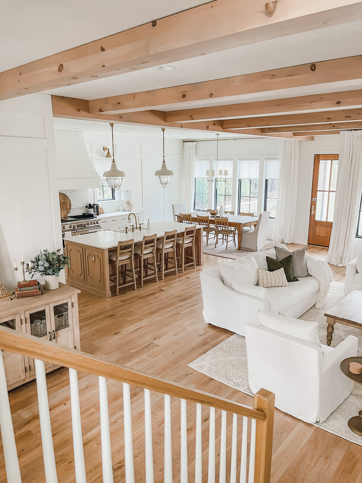 The large, open staircase allows views across the entire first floor including the living room, kitchen and dining room