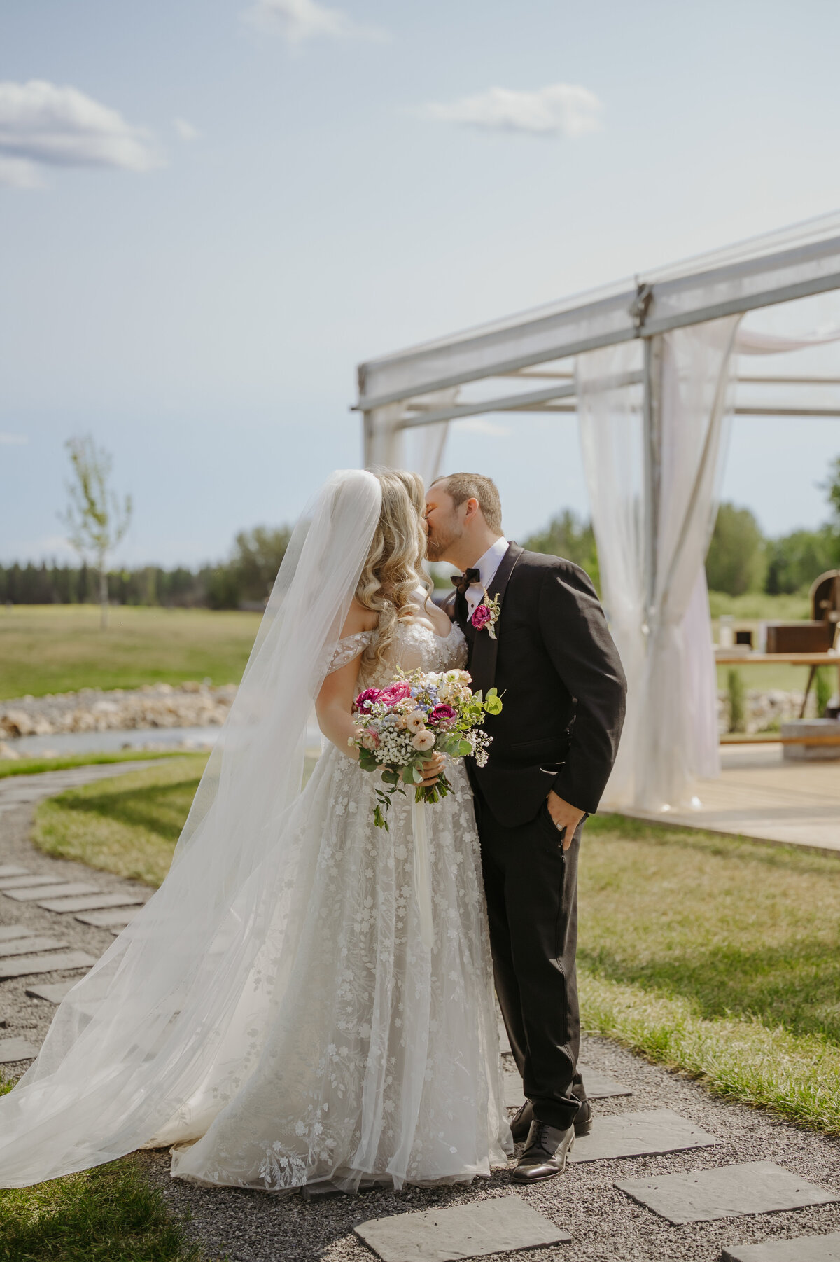 Couple kissing after ceremony at Gardenview Estates