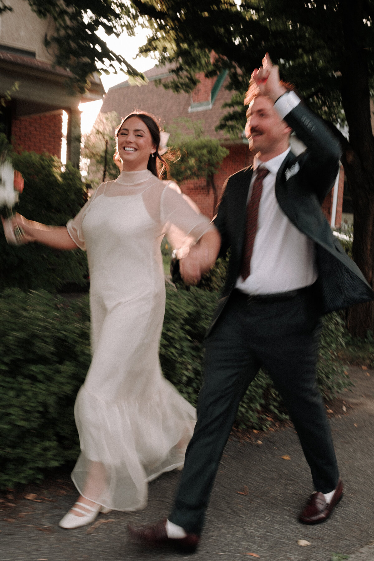 happy newlyweds wakling through the street