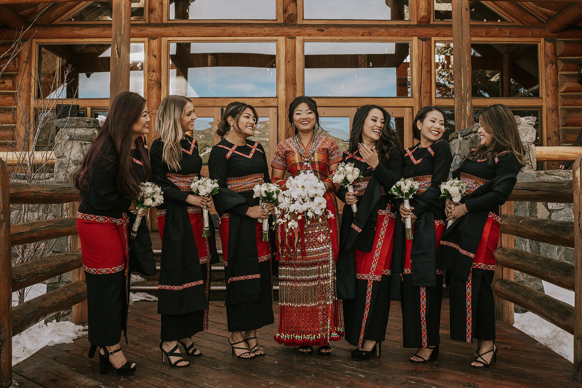 Southeast Asian bride and her bridesmaids pose in traditional dresses for her wedding day.