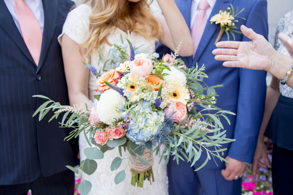 stunning colorful bridal bouquet detail on  bright wedding day