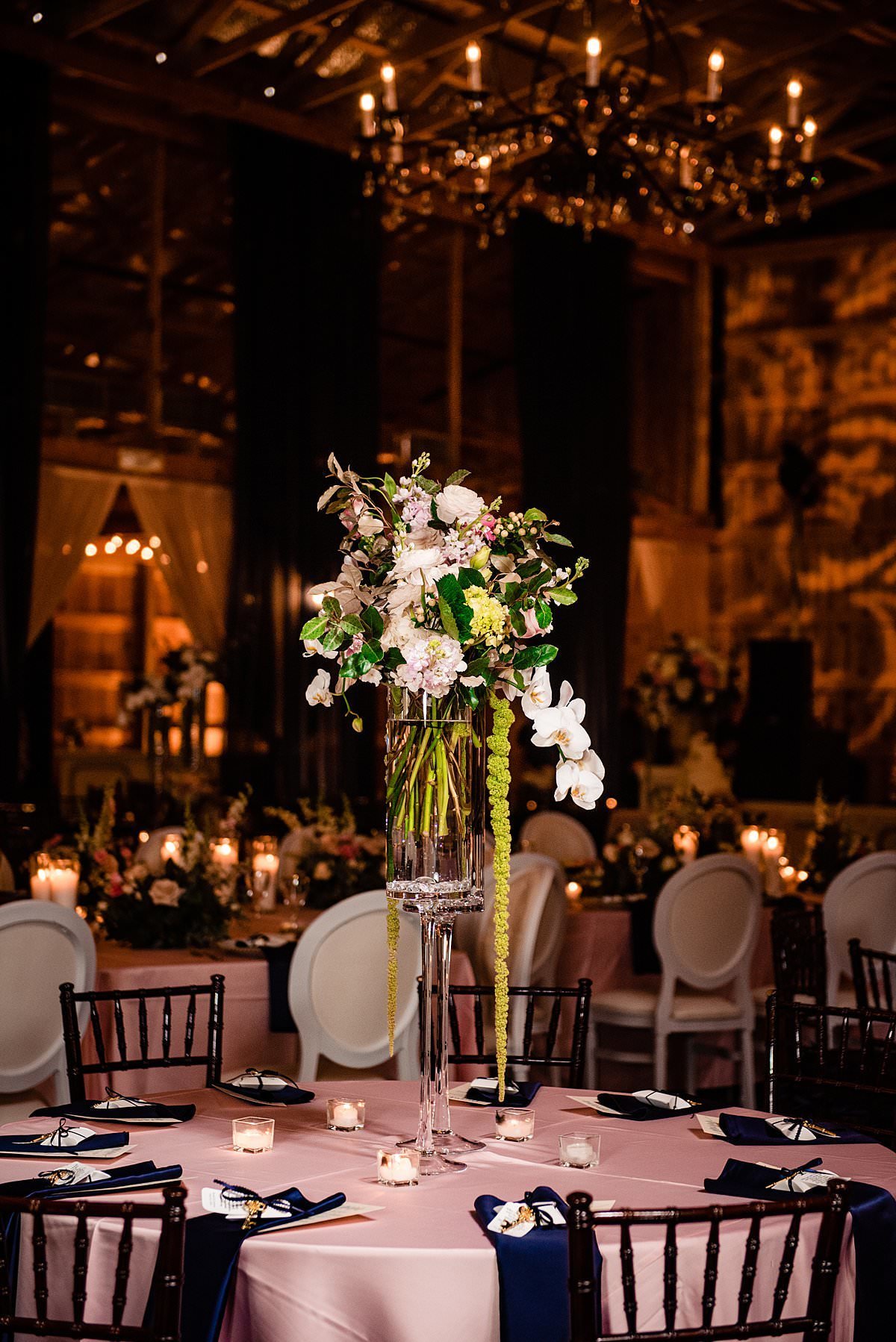 Tall centerpieces with orchids and hanging greenery