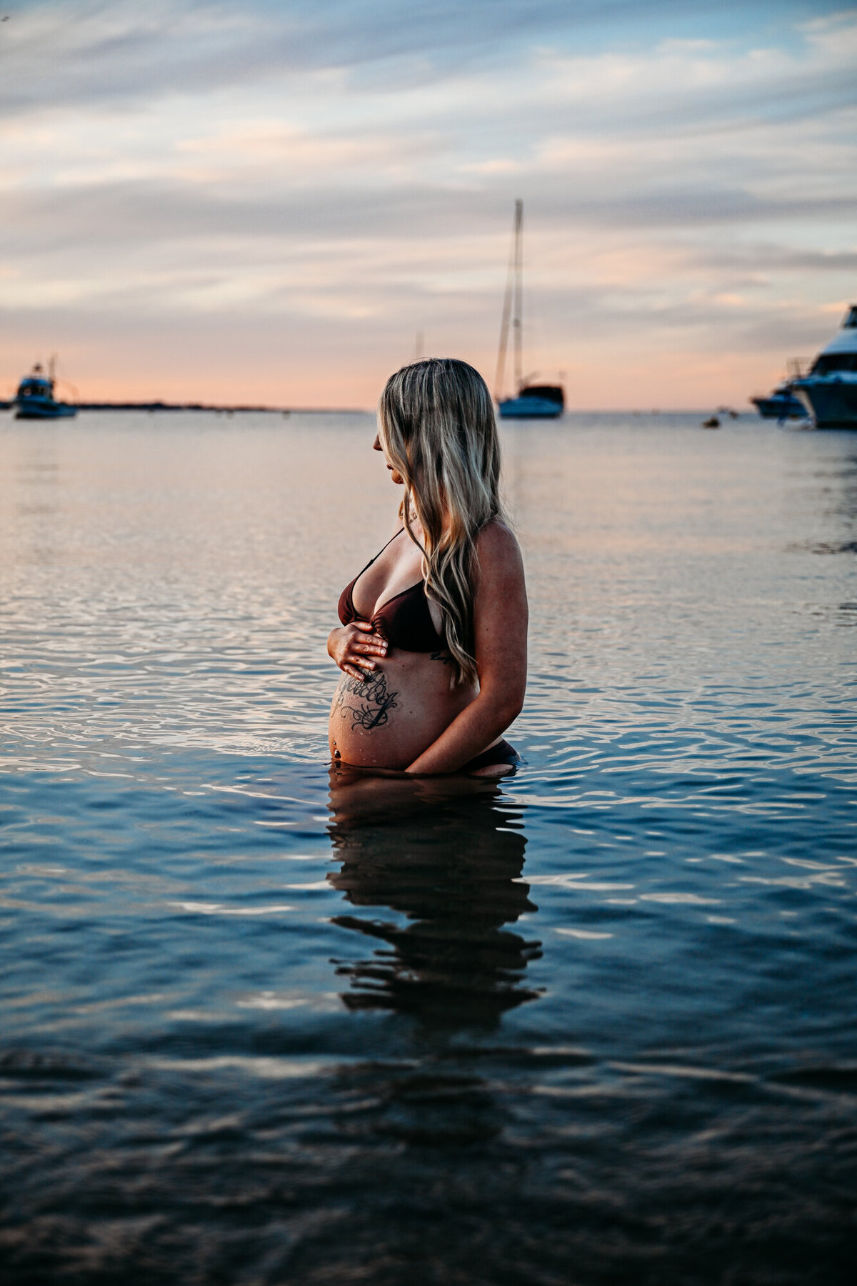Pregnant mom in the water during her maternity photoshoot
