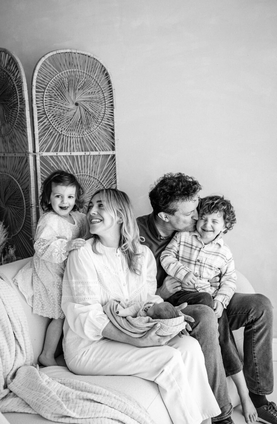 Monochrome image of a happy family with a newborn, toddler, and young child in Mullingar