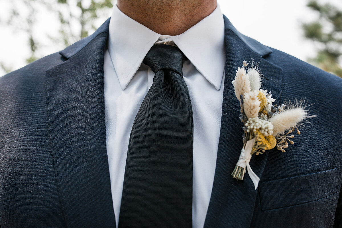 Close up of groom's tie and suit jacket