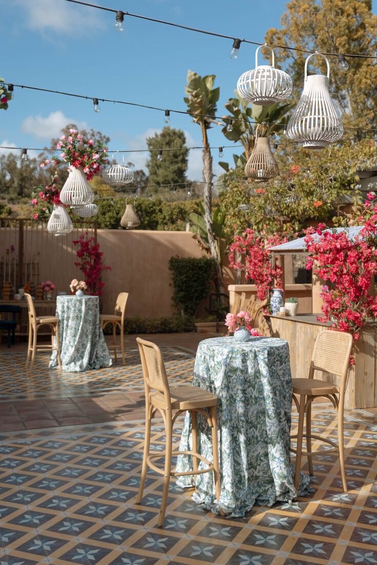 Outdoor wedding cocktail hour setup with patterned tile floor and lounge seating, editorial bar inspiration for Airlie Gardens