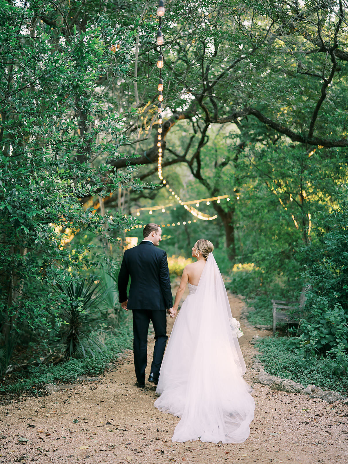The bride and groom walk together down the nature trails at Laguna Gloria