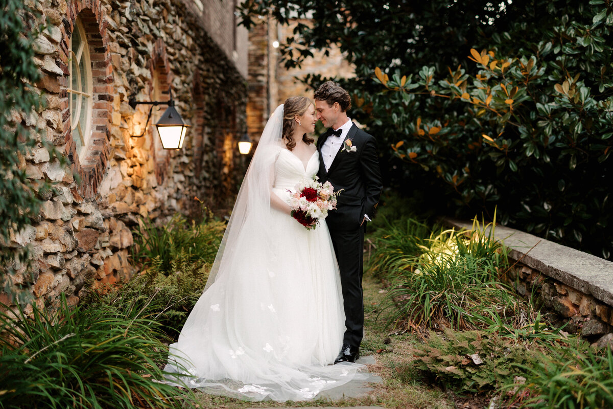 November wedding at Graylyn Estate, designed and planned by Charming Carolina — bride and groom looking at each other lovingly during golden hour outside the estate.