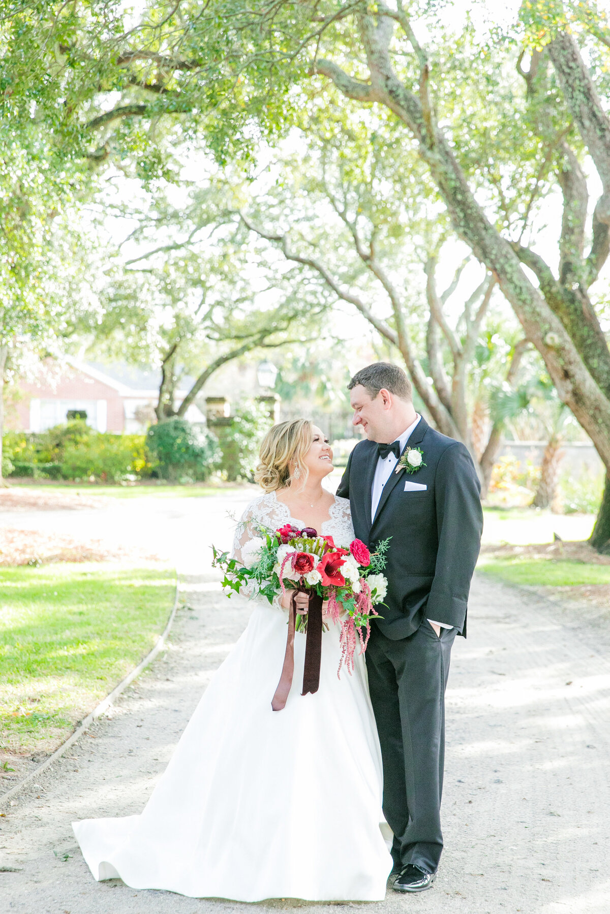 couple poses on wedding day at lowndes grove