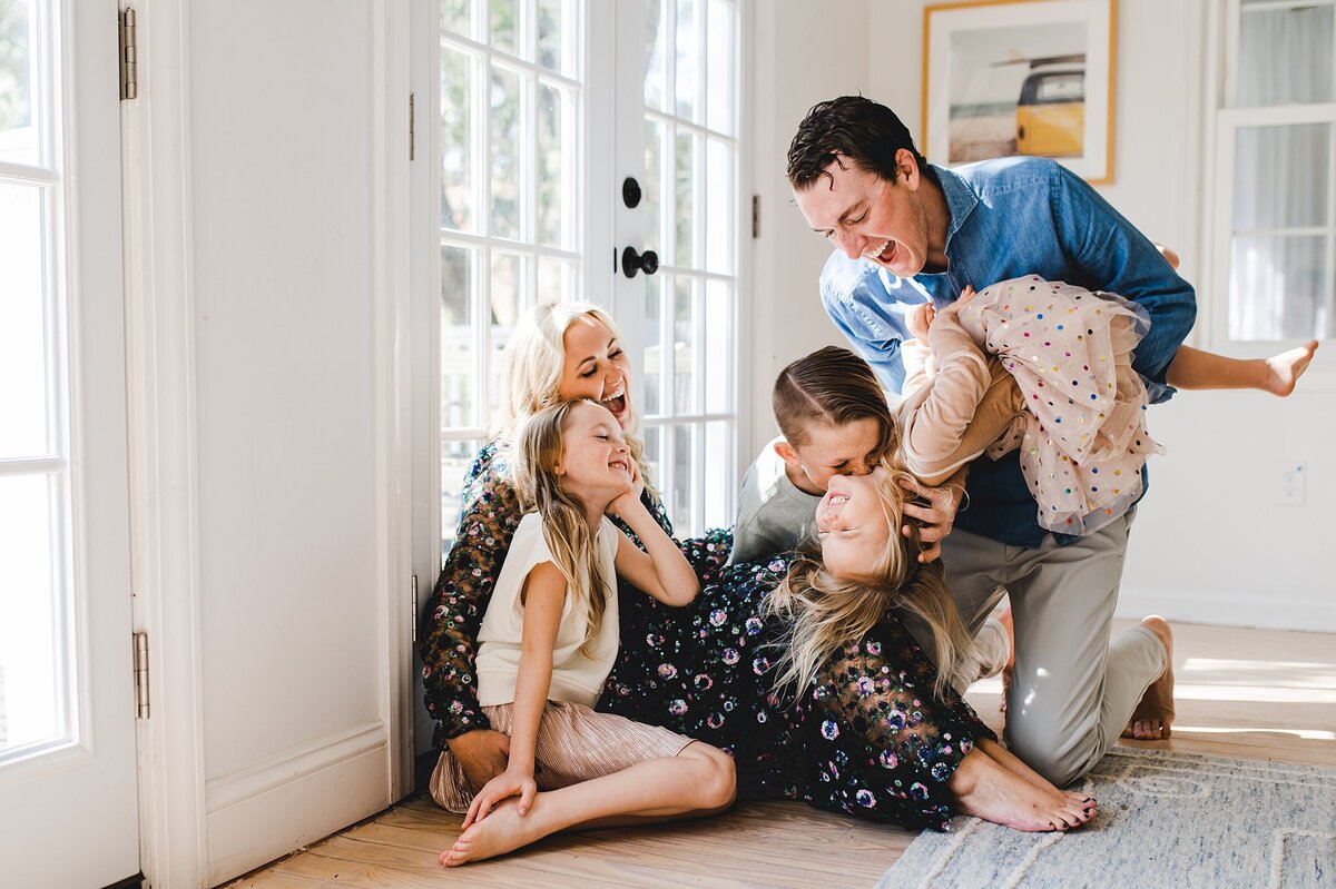 a family has fun during their photography session at home