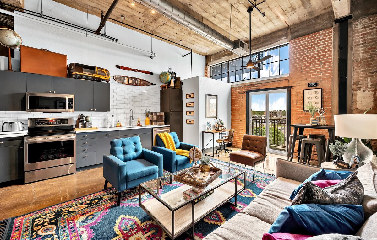 Living room with view of downtown in this two-bedroom, two-bathroom vacation rental condo in the historic Behrens building in downtown Waco, TX just blocks from the Silos, Baylor University, and Spice Street.