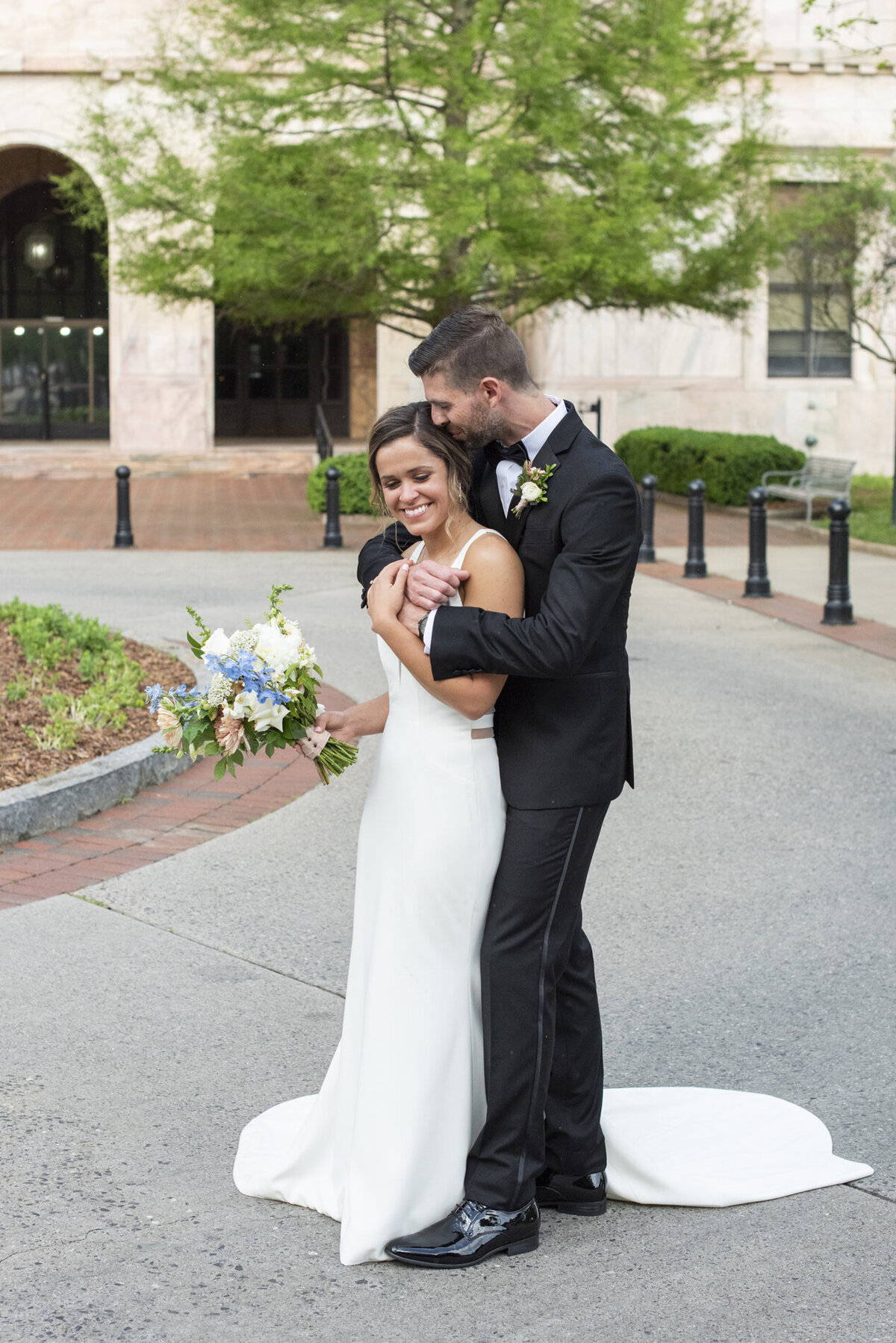 Couple snuggling at Century Room on the Park Asheville wedding