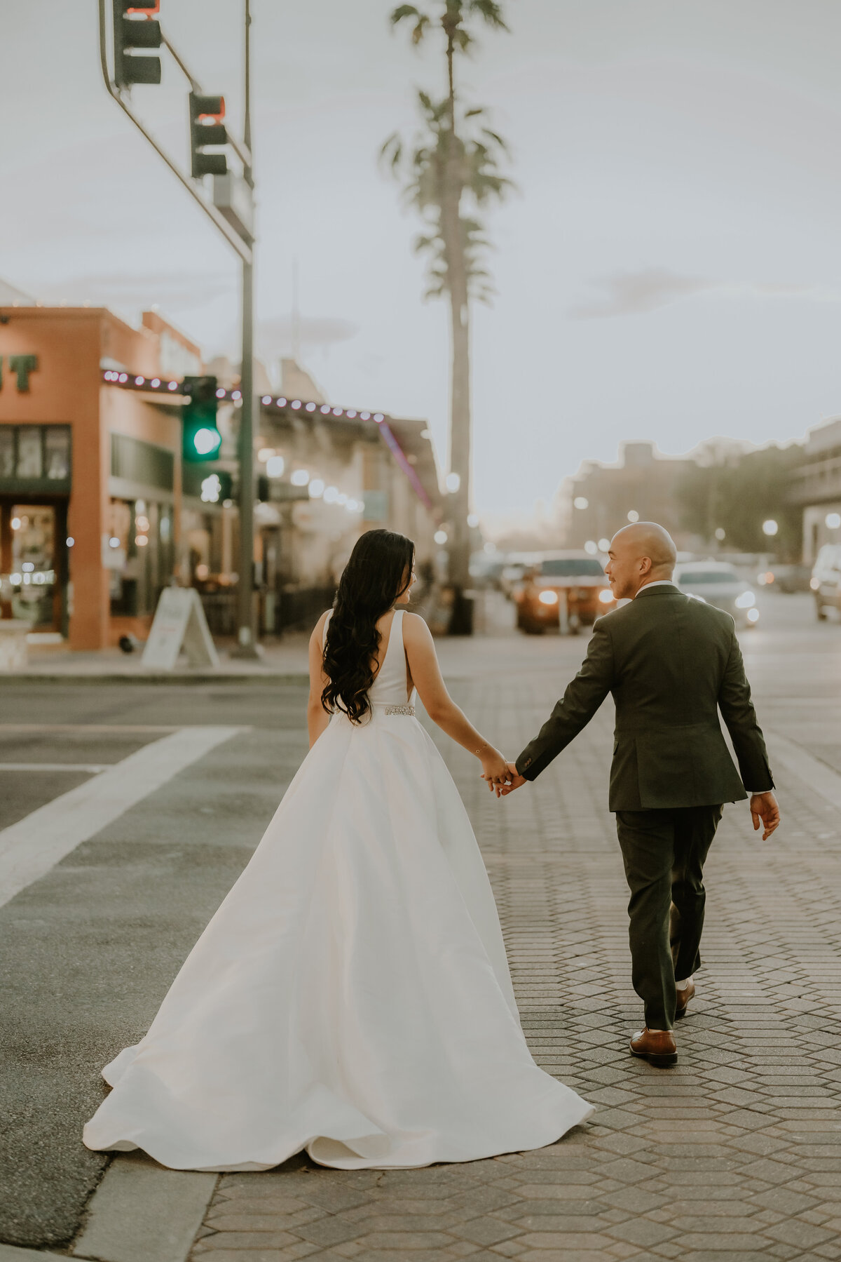 Bride and Groom walking the streets with palm trees Temecula, California Wedding photographer Yescphotography
