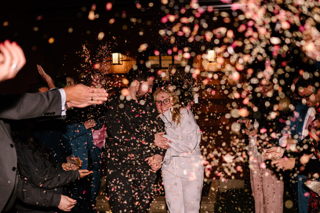 guests tossing confetti at wedding