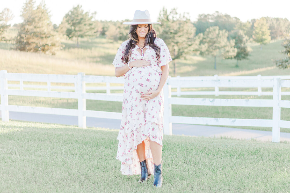 mom facing camera while holding belly looking down during 5U Photography session