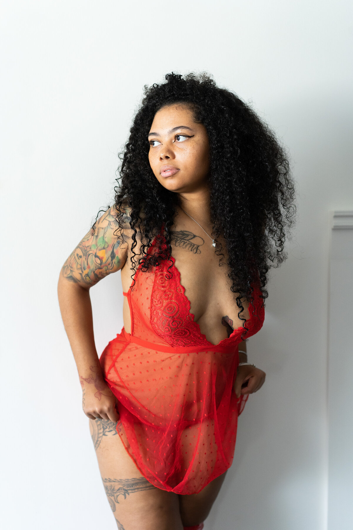 Woman embracing her beauty during a personalized boudoir session.