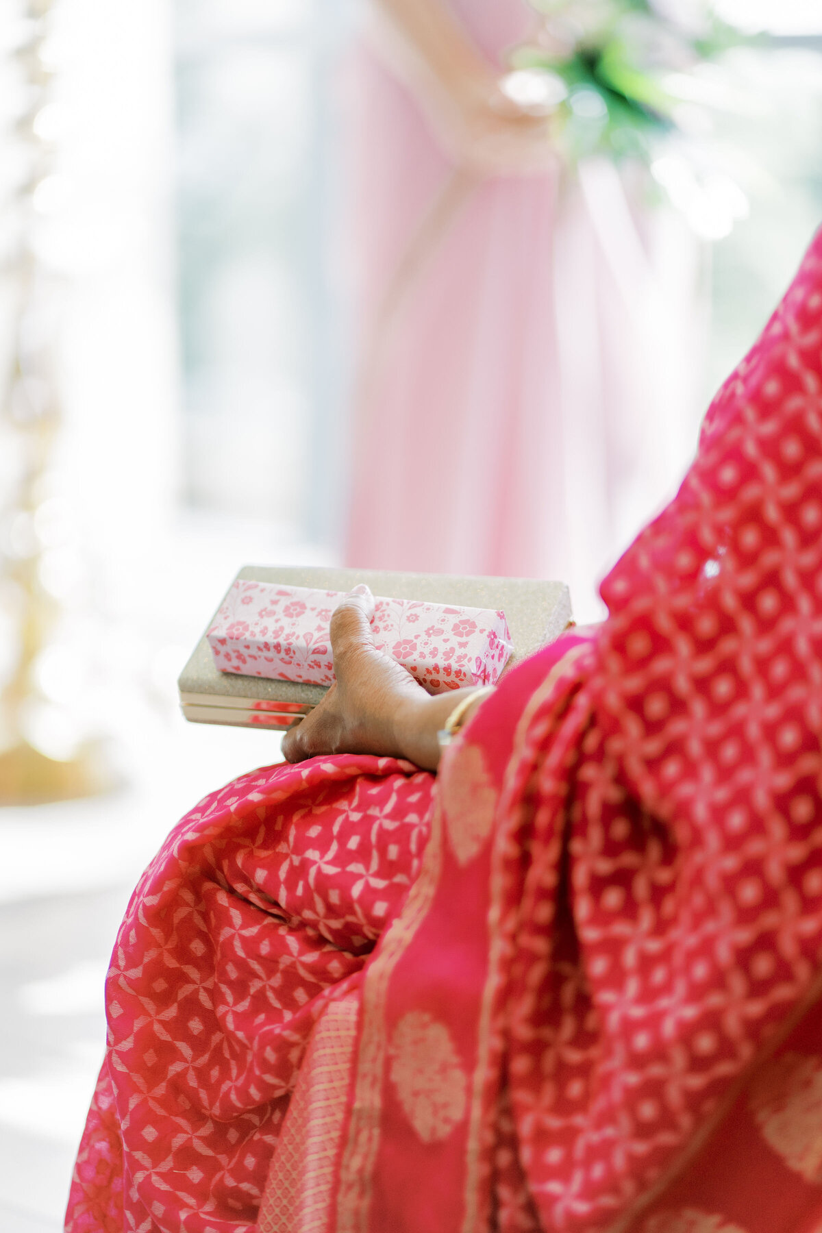 Guest holding her purse at an indian wedding at the pearle hotel