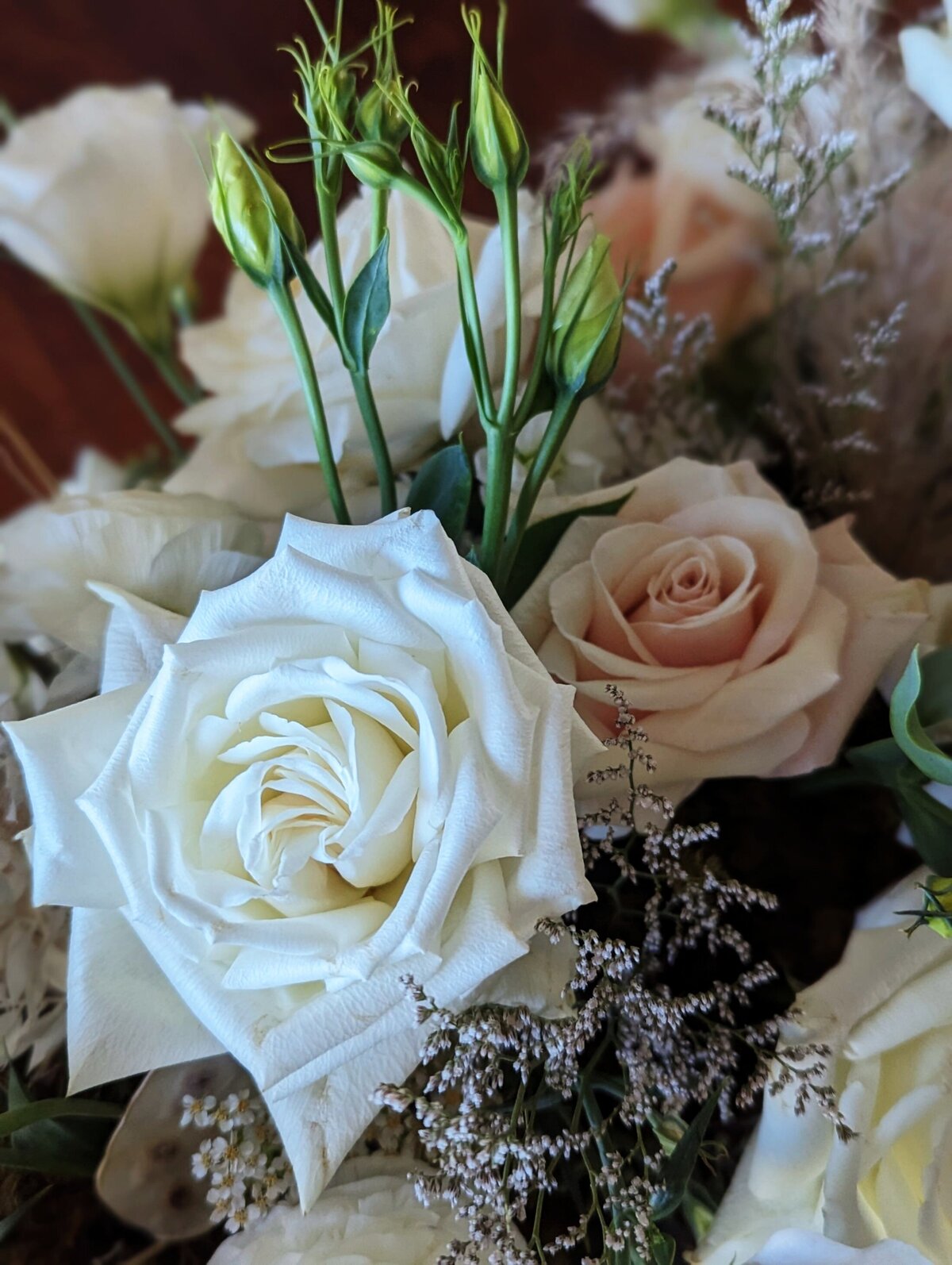 white funeral flowers with soft pink detail