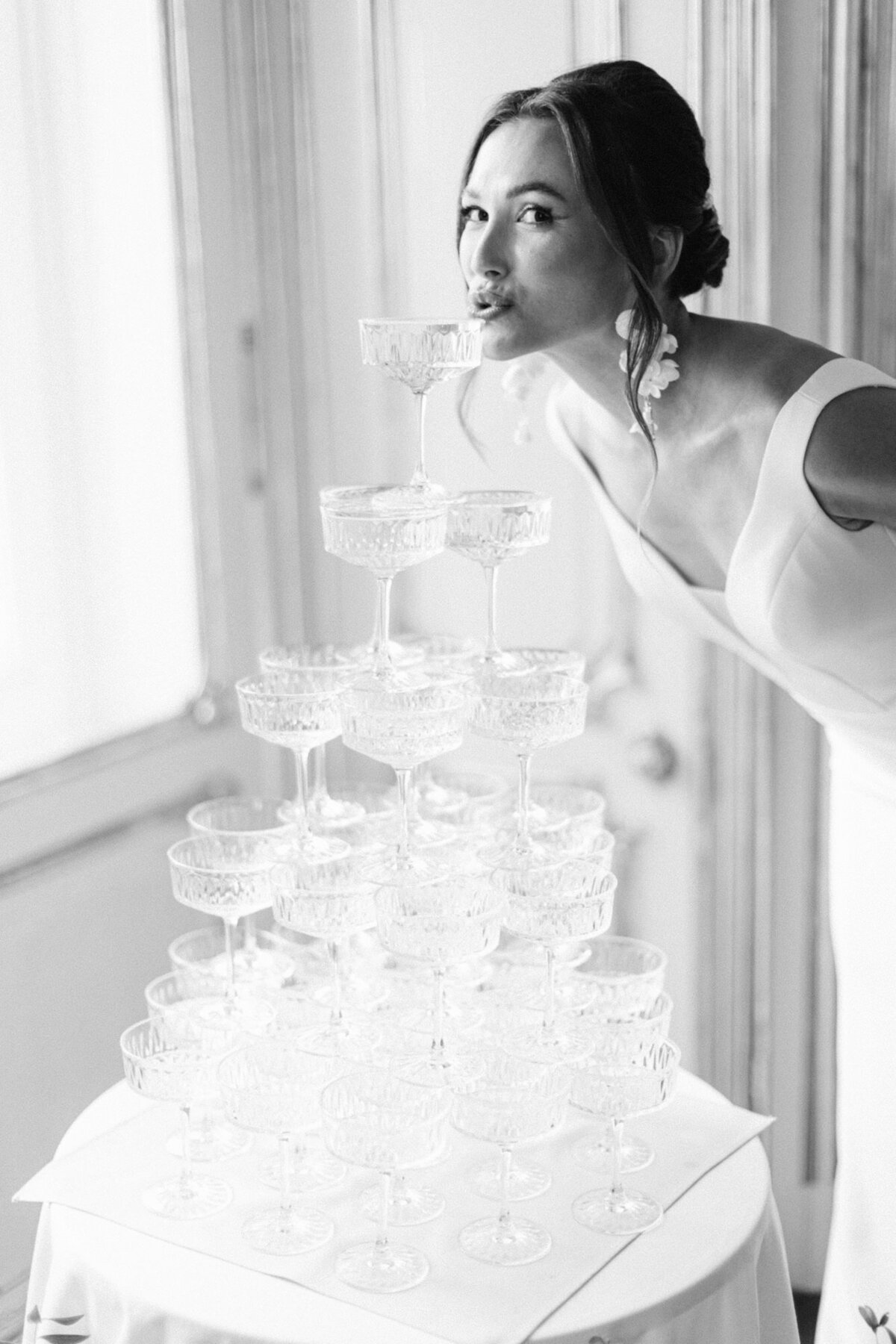 Luxury bride sipping on champagne tower after the ceremony at palace Coburg in Vienna