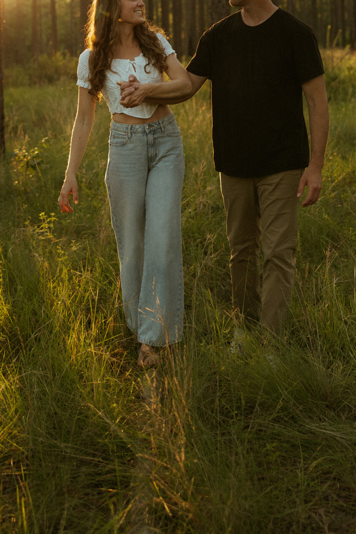 Couple posing for portraits in a forest.