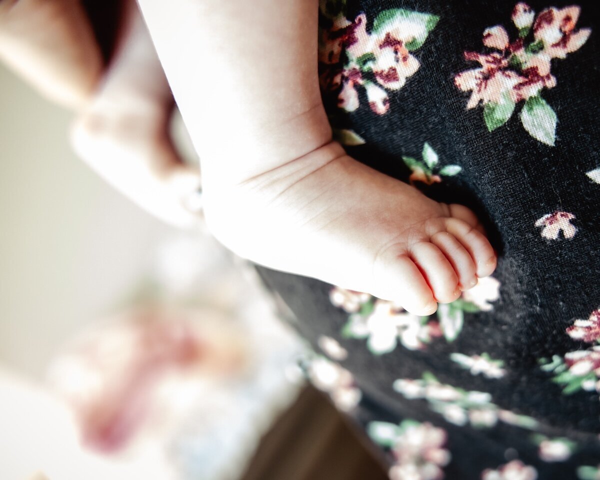a close up of a newborn baby girl's feet
