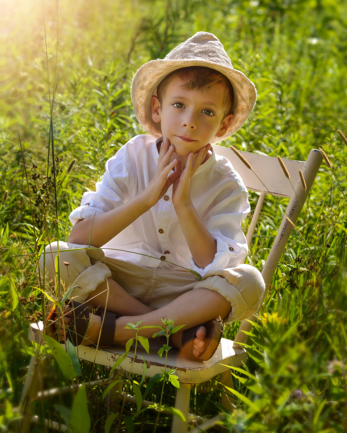 Milestone portrait of a boy in nature during golden hour—vintage vibes with peaceful summer tones.
