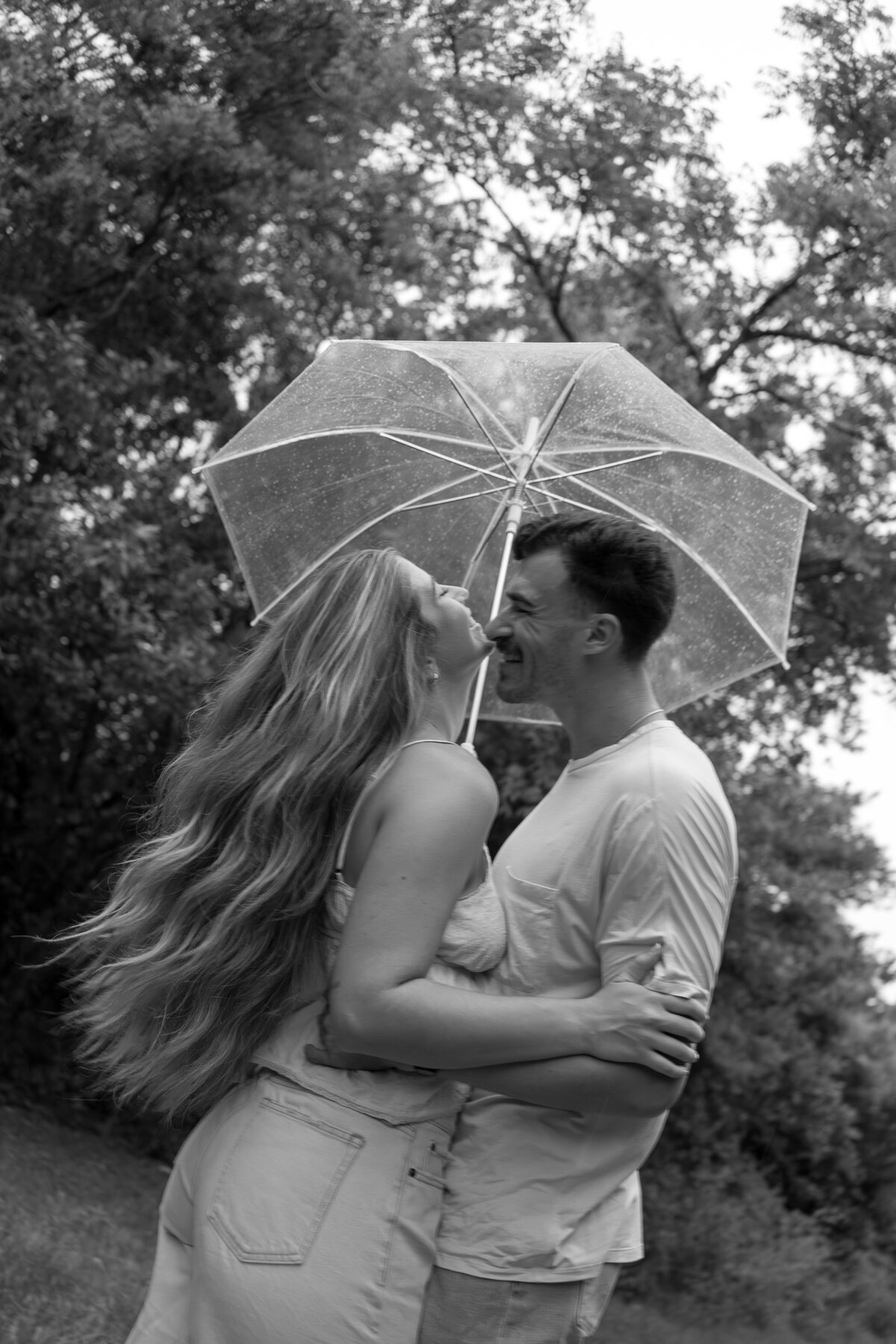 couple laughing and holding umbrella by florida engagement photographer Shelby Ann Photos