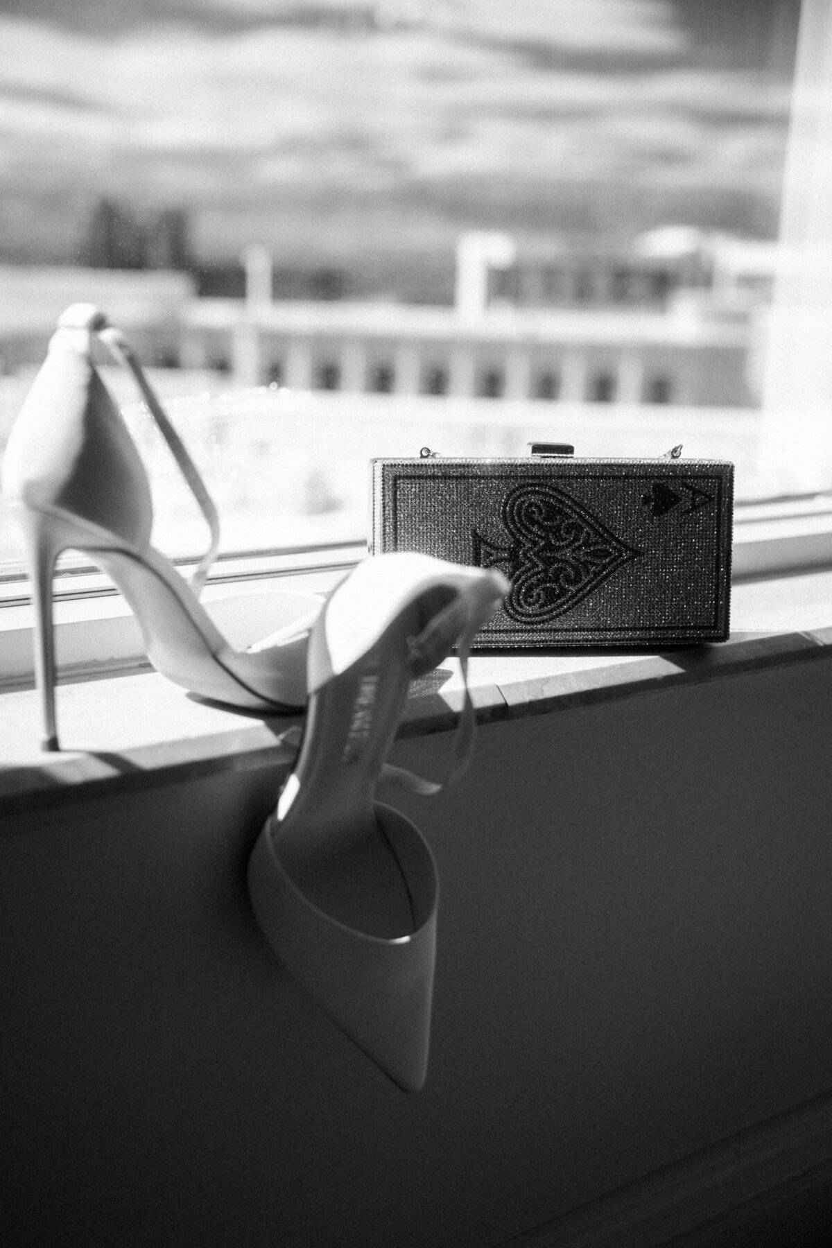 close up of brides wedding shoes sitting in window