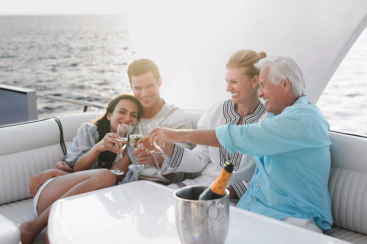 Family enjoying champagne on a yacht, representing lifestyle freedom and financial clarity supported by TMW Advisory’s services

