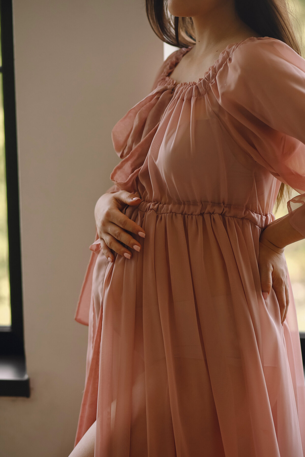 close-up-photo-pregnant-belly-pregnant-woman-pink-dress-holding-her-hand-belly