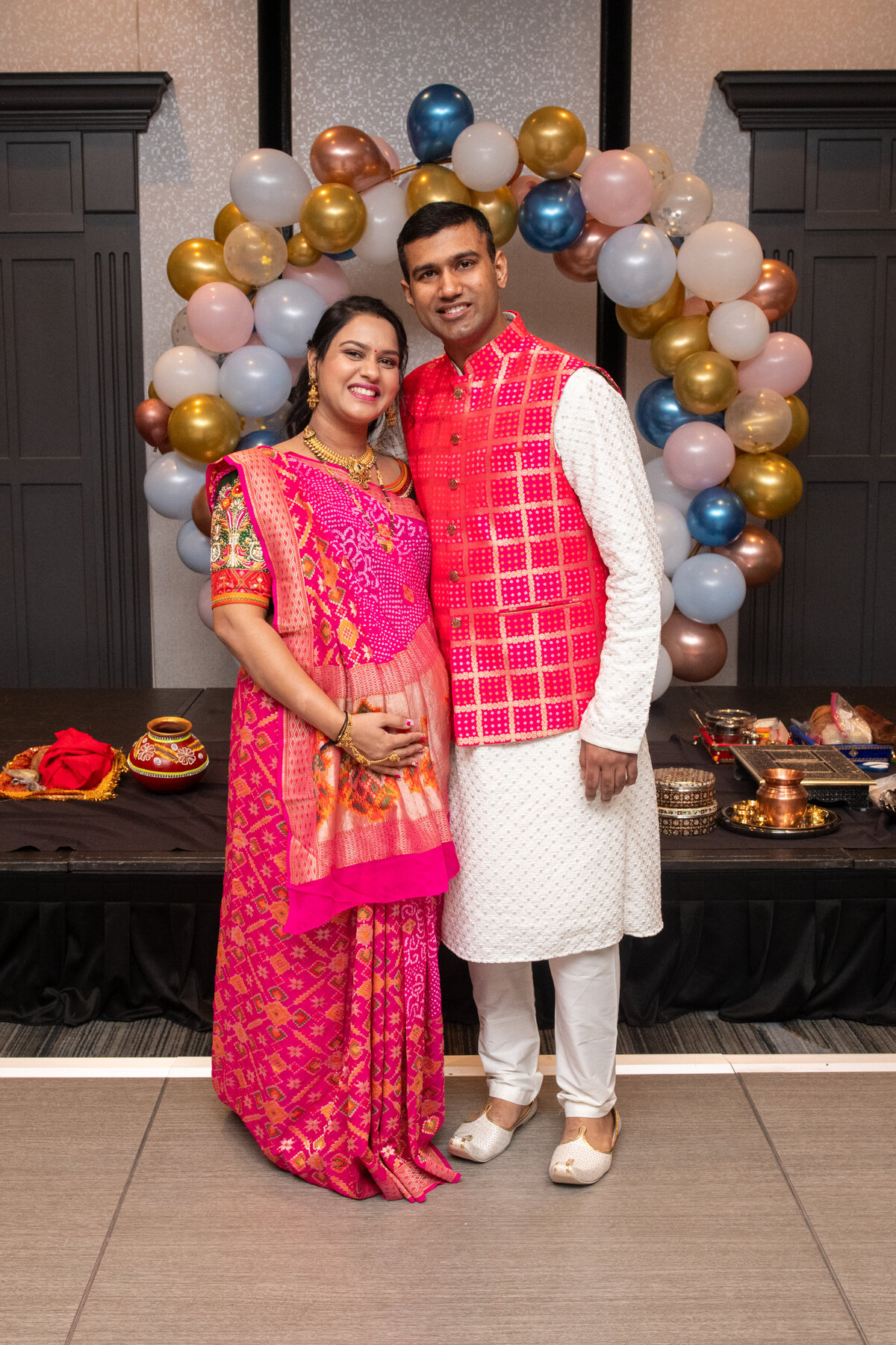 happy couple pose at Godh Bharai