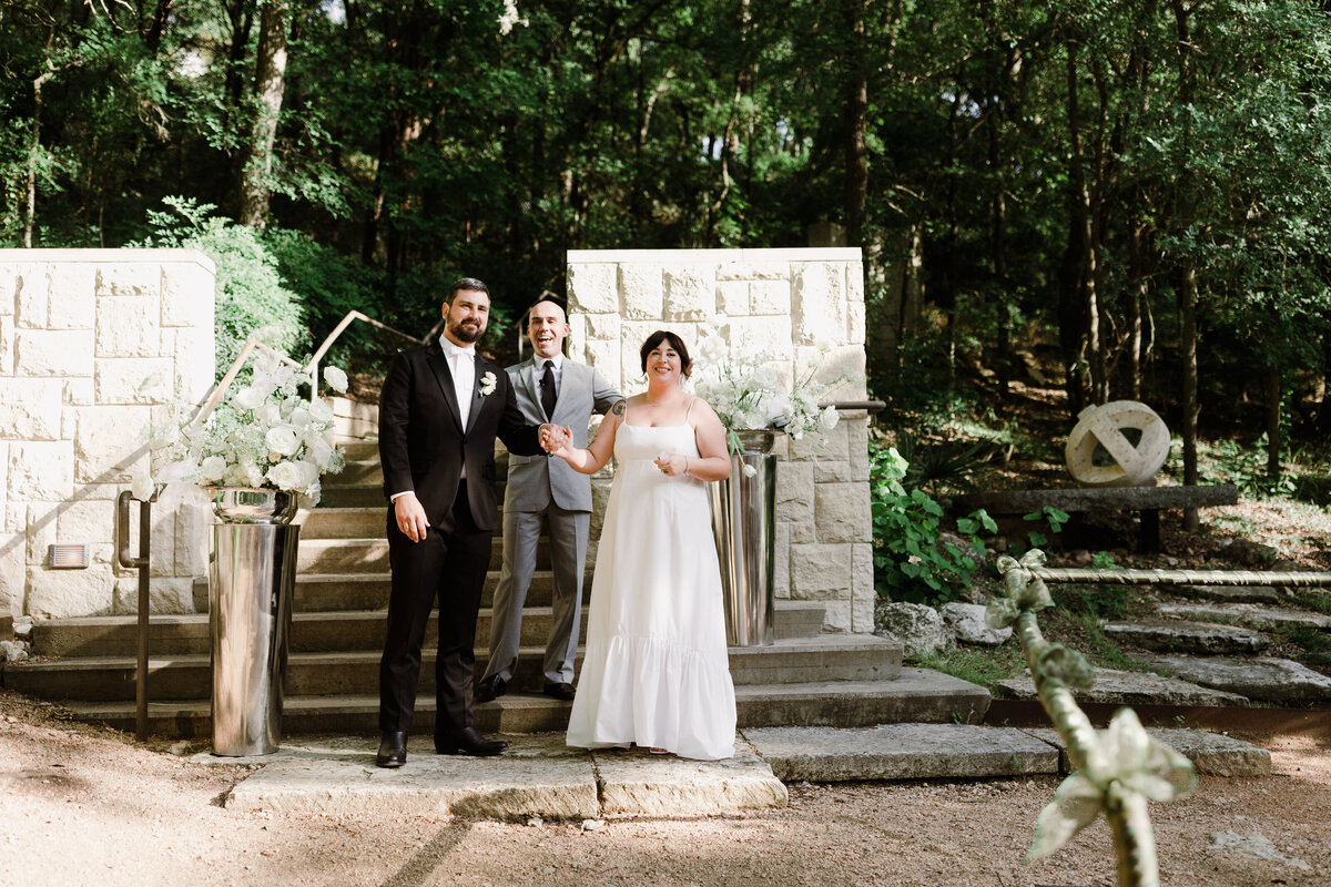 Bride and groom at outdoor wedding ceremony at Umlauf Sculpture Garden, Austin